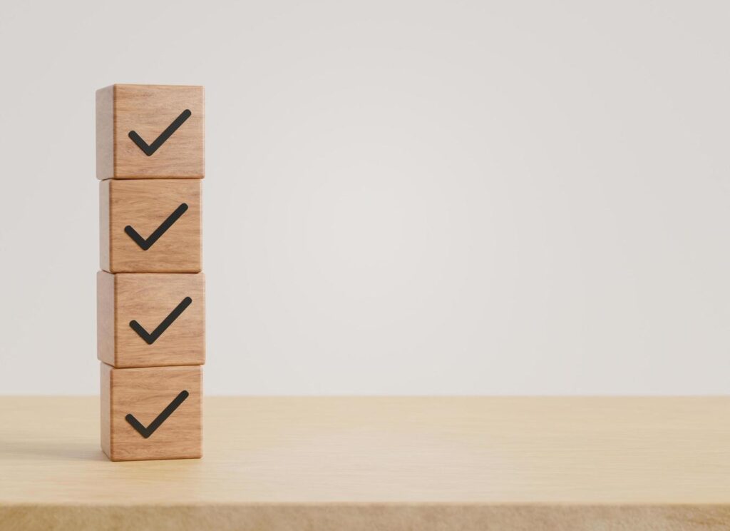 Wood cube with check mark with copy space on wooden floor background. business concept, 3D rendering. Stock Free