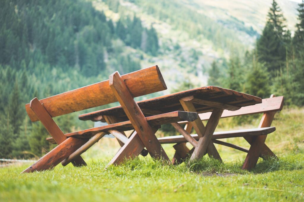 Wooden Picnic Seating Area in the Middle of Mountains Free Photo