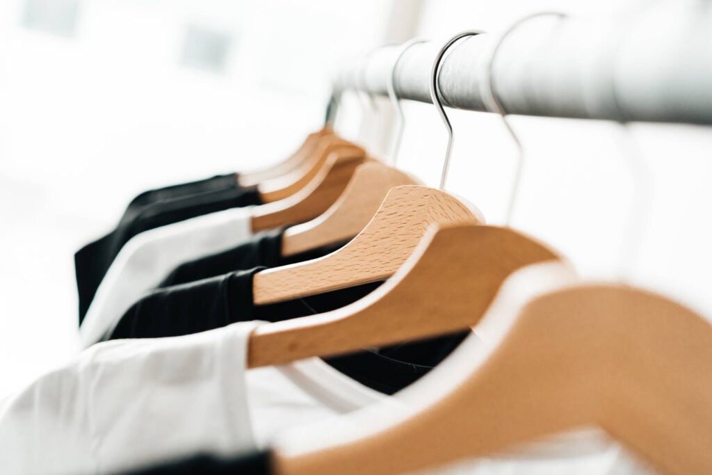 Wooden T-Shirt Hangers in Fashion Apparel Store Free Photo