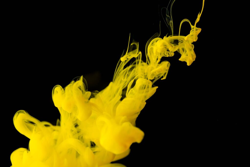 Yellow Ink in Black Water Free Photo