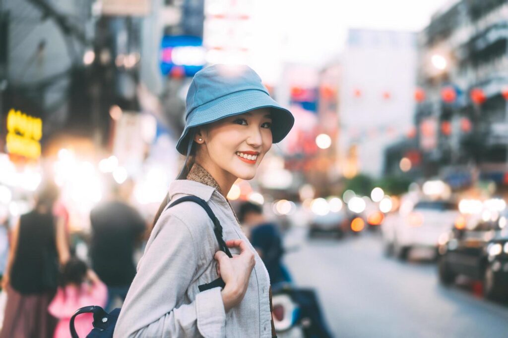 Young adult asian woman traveller backpack traveling in city lifestyle chinatown street food with bokeh background. Stock Free