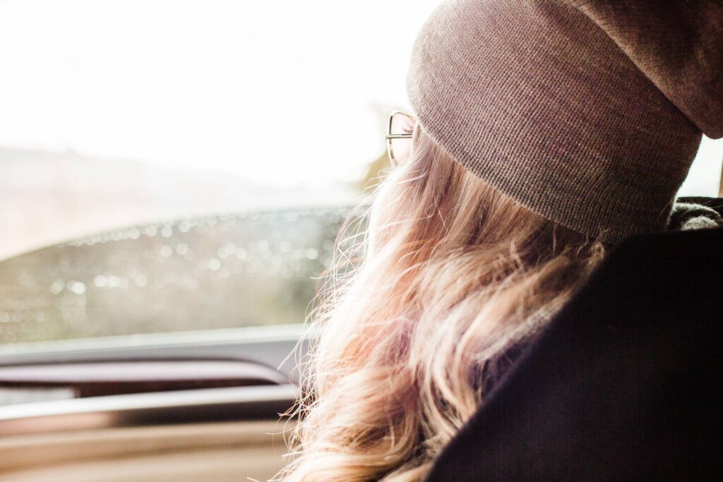 Young & Beautiful Blonde Girl Looking Out of Car Window Free Photo