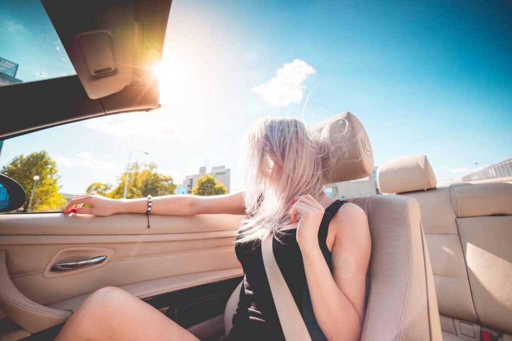 Young Blonde Girl on Summer Ride in Convertible Free Photo