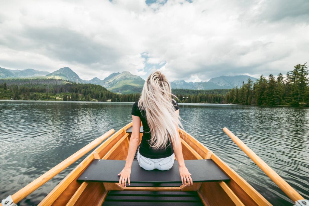 Young Blonde Woman Enjoying a Rowing Boat Free Photo