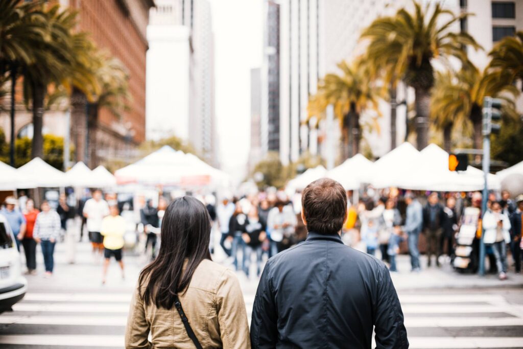 Young Couple Looking on the Other Side of the Crosswalk Free Photo