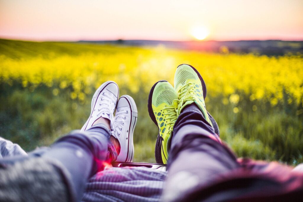 Young Couple Relaxing & Enjoying The Sunset from The Car Free Photo