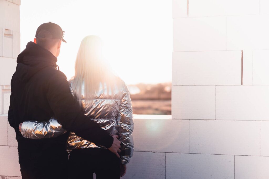 Young Couple Standing on The Construction Site of Their New House Free Photo