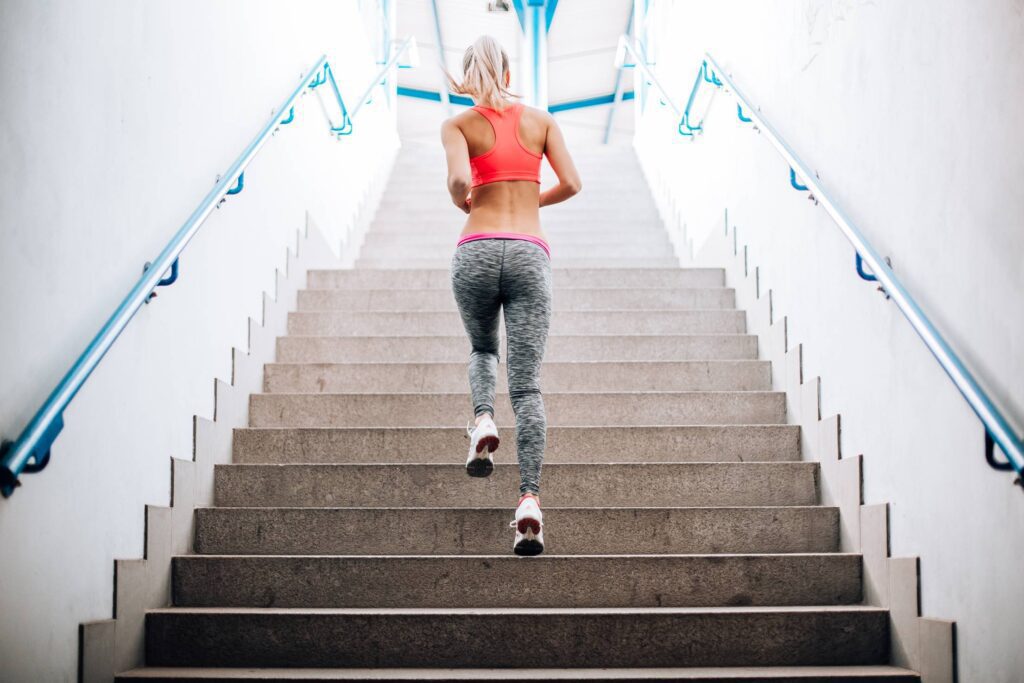 Young Fitness Girl Running Up The Stairs Free Photo