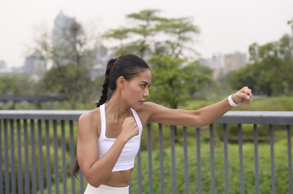 Young fitness woman in sportswear boxing in city park, Healthy and Lifestyles. Stock Free