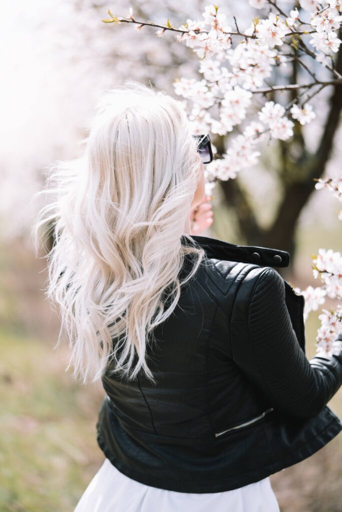 Young & Free Woman Enjoying a Blooming Almond Orchard Free Photo