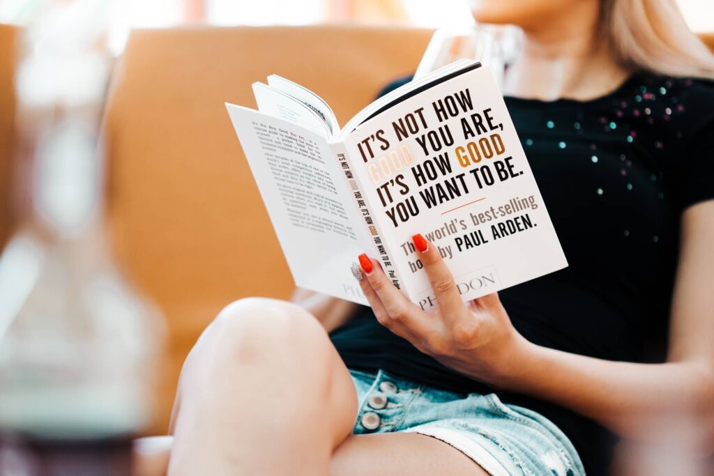 Young Girl Reading a World’s Best-Seller Book Free Photo