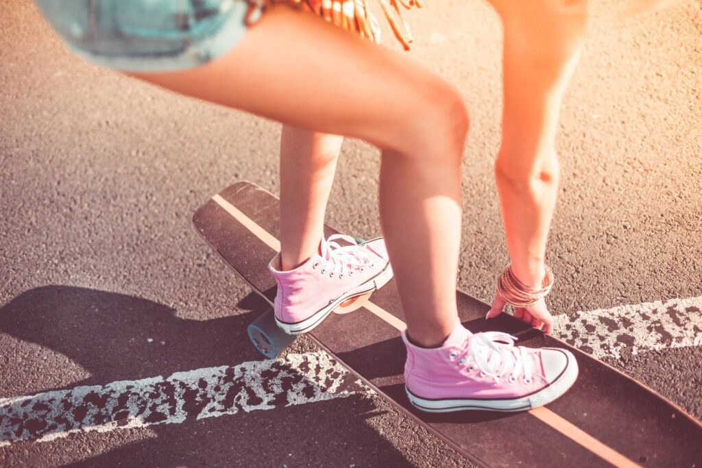 Young Girl with Pink Shoes on Longboard Free Photo