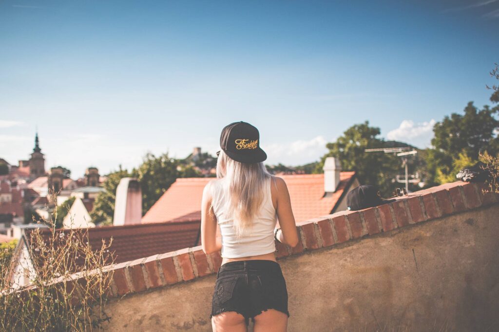 Young Girl with Snapback Looking over the Old City Free Photo