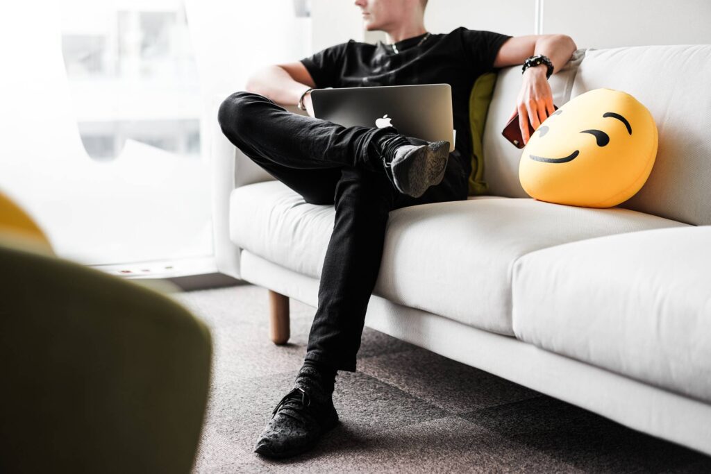 Young Man Thinking and Working with Laptop in Office Space Free Photo