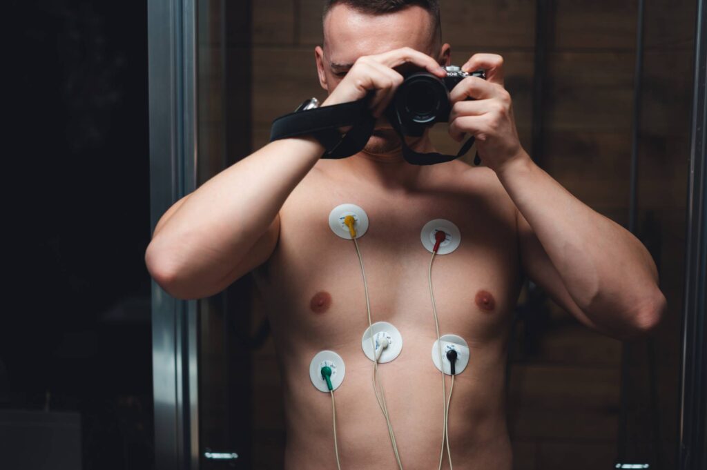 Young Man with Portable ECG Holter Monitor Free Photo