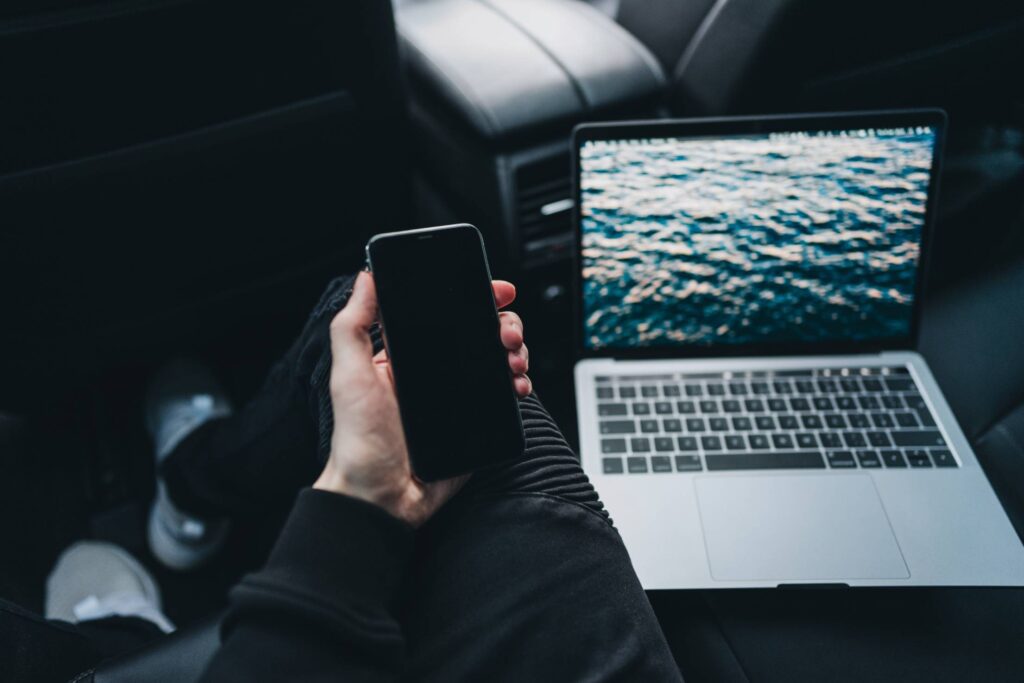 Young Man Working from a Car Free Photo