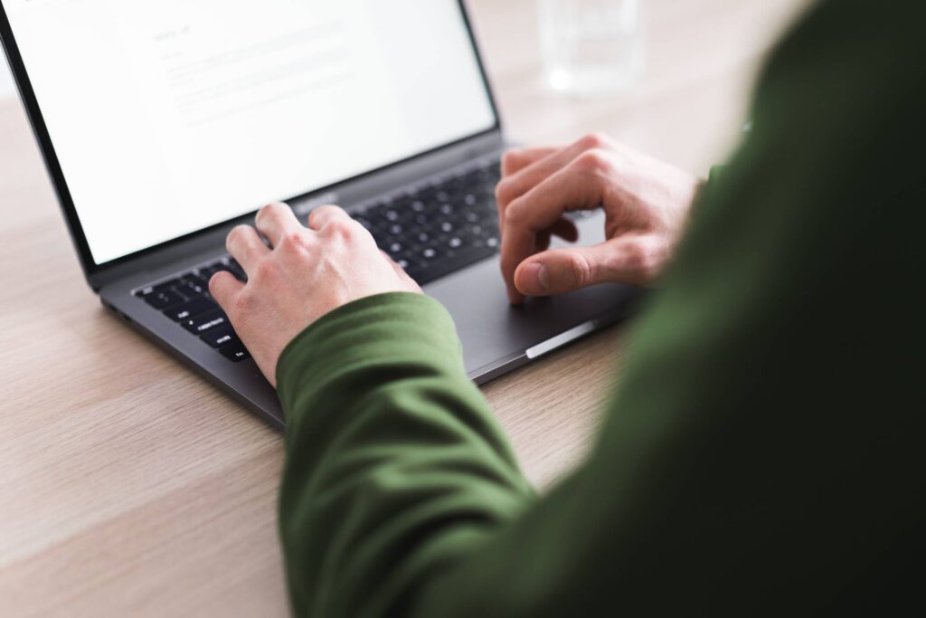 Young Millennial Man Working on His MacBook Laptop Free Photo