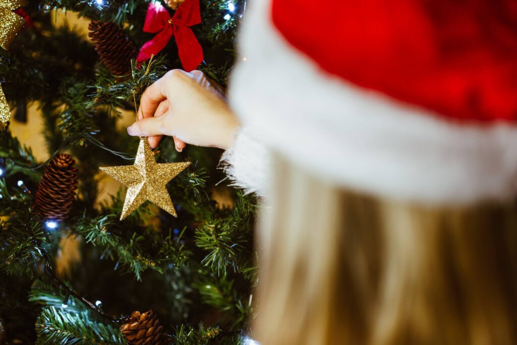 Young Woman Decorating a Christmas Tree Free Photo