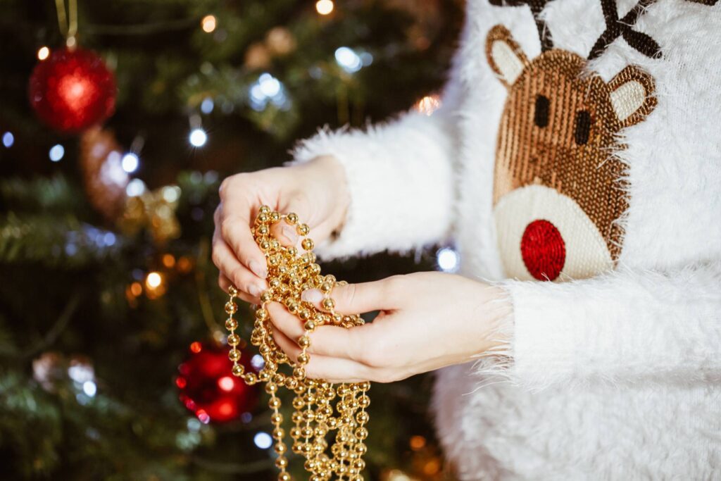 Young Woman Decorating Christmas Tree Free Photo