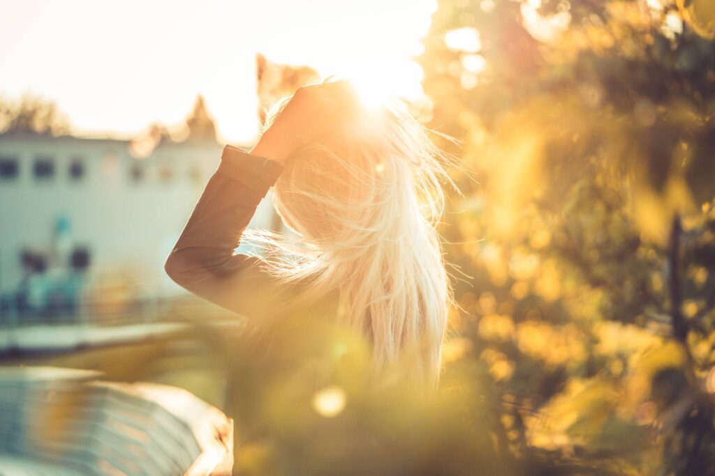 Young Woman Emotionally Touching Her Hair Free Photo