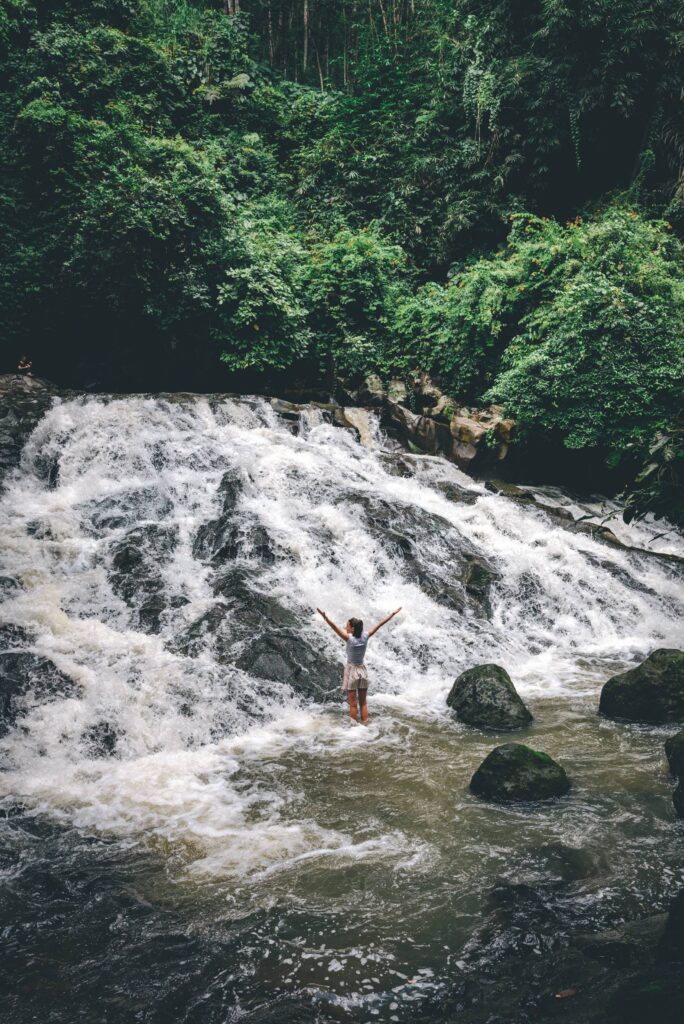 Young Woman Enjoying Waterfall in Bali Free Photo