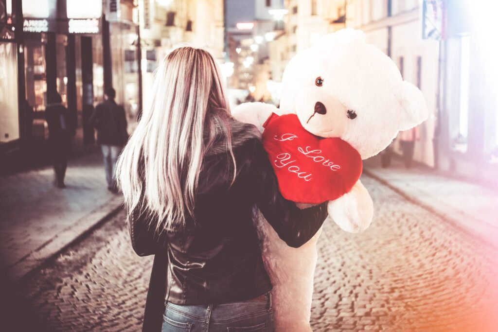 Young Woman Holding Her Big Valentine’s Day Gift Teddy Bear Free Photo