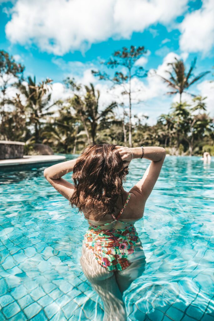 Young Woman in Luxury & Exotic Swimming pool Free Photo