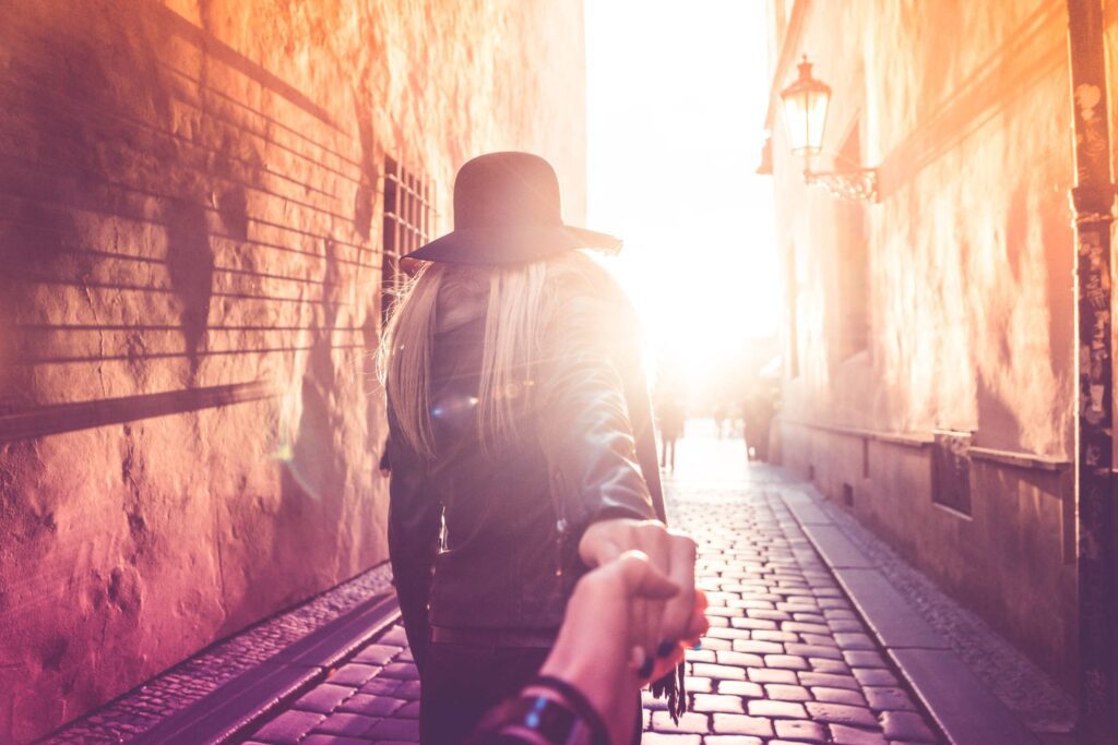 Young Woman Presents Follow Me To Pose in Prague Streets Free Photo