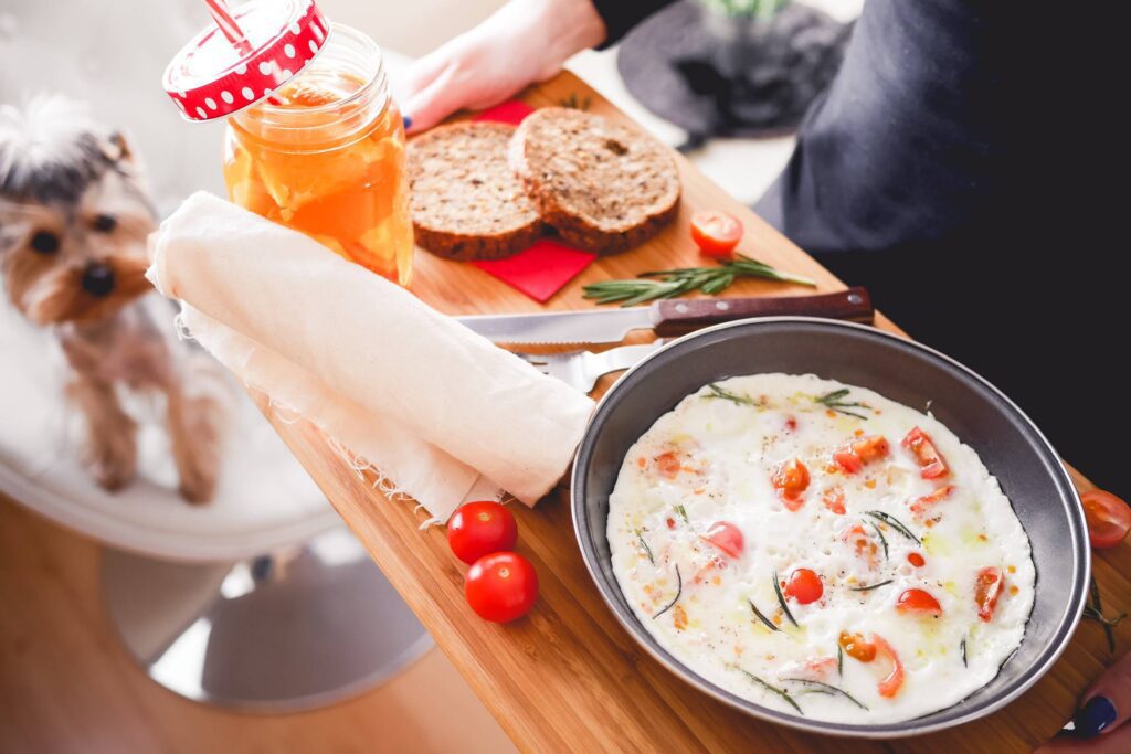 Young Woman Serving Lovely & Homemade Breakfast Free Photo