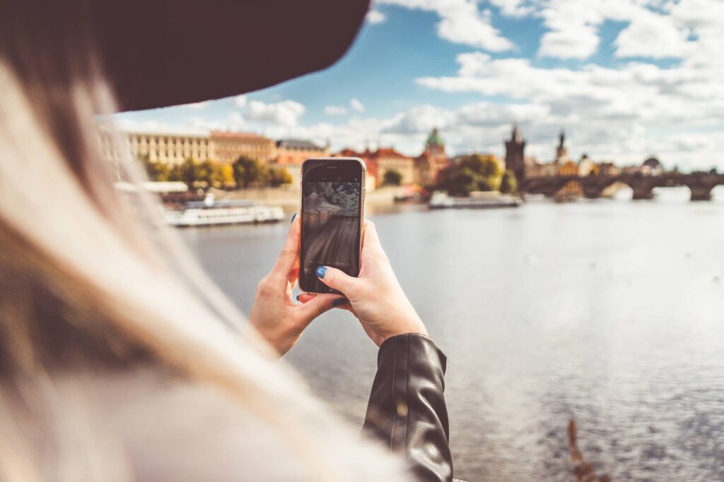 Young Woman Taking a Photo with Her iPhone Free Photo