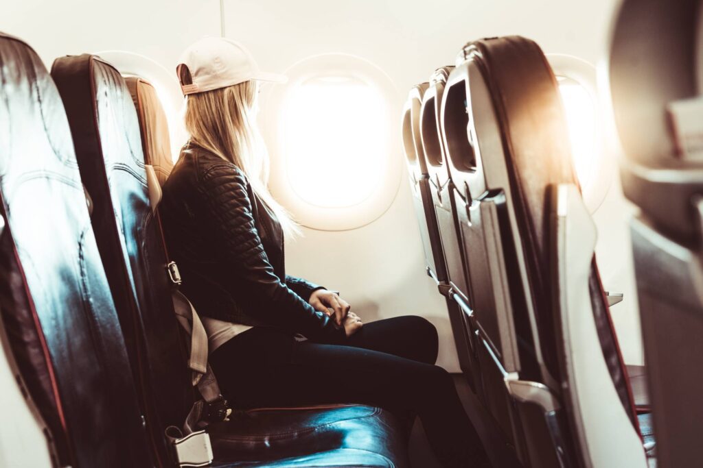 Young Woman Traveling by Airplane Free Photo