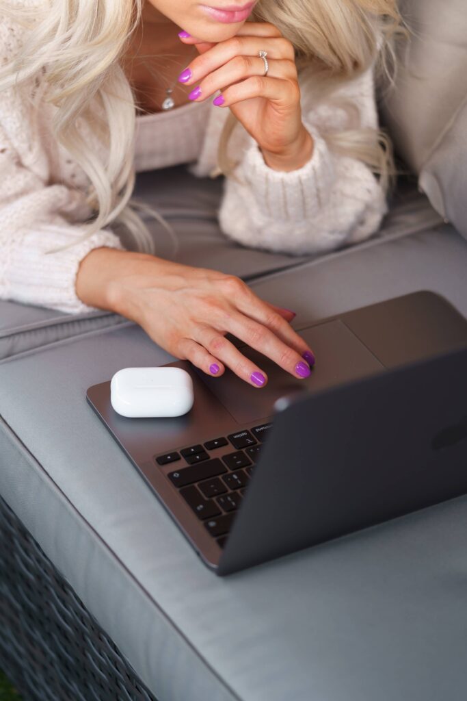 Young Woman Using Her Laptop on a Garden Seat Free Photo