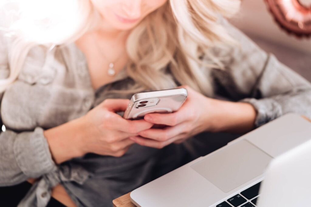 Young Woman Using Her White Smartphone at Home Free Photo