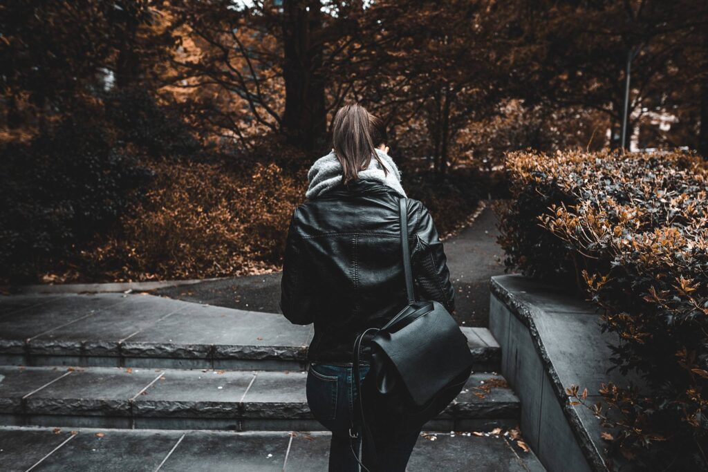 Young Woman Walking Alone in Park Free Photo