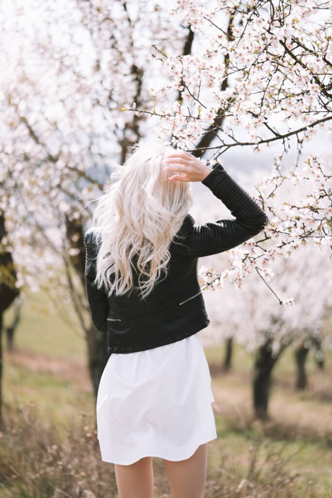 Young Woman Walking Through an Almond Orchard Free Photo