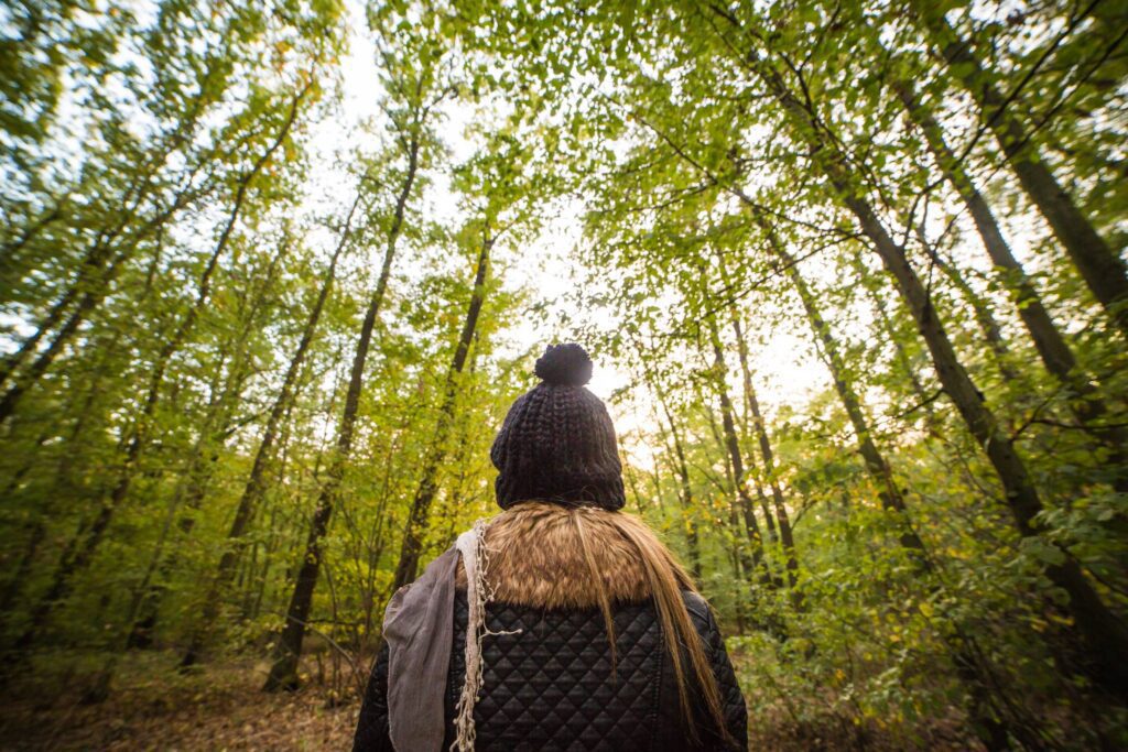 Young Woman Walking Through The Forest Free Photo