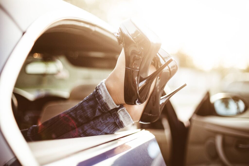 Young Woman With High Heels in Car Transport Limousine Service Free Photo