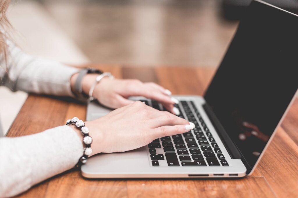 Young Woman Working/Typing on Her Laptop Free Photo