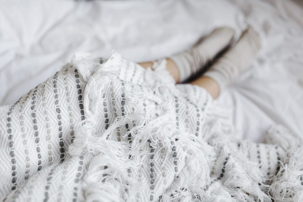 Soft photo of woman on the bed with the book and cup of coffee in hands Stock Free