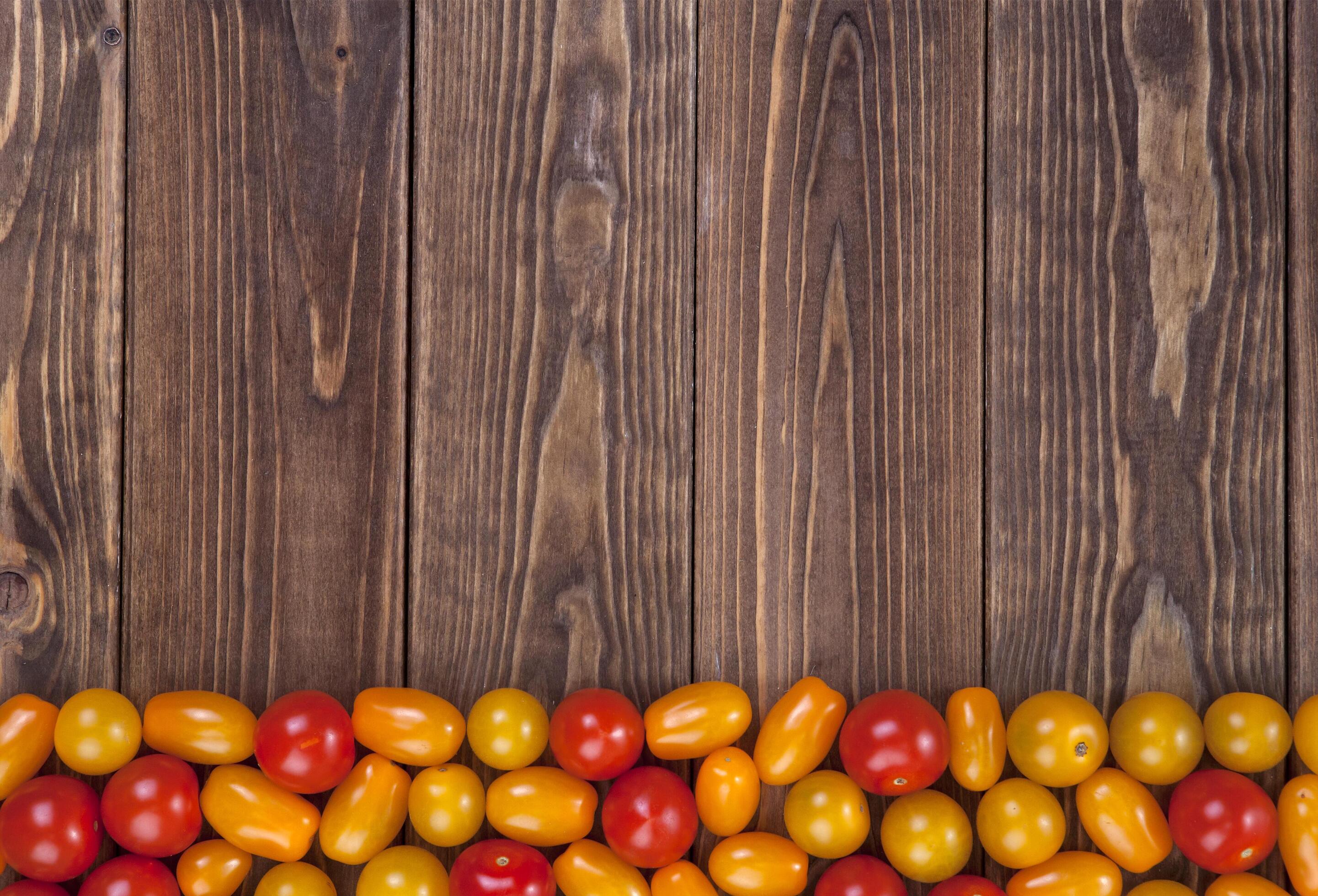 Cherry tomatoes on wooden table background, top view Stock Free