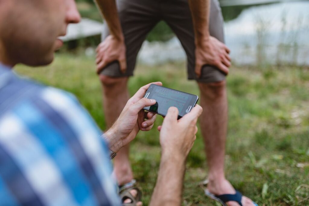 Closeup of man hands playing videogames on cell phone Stock Free