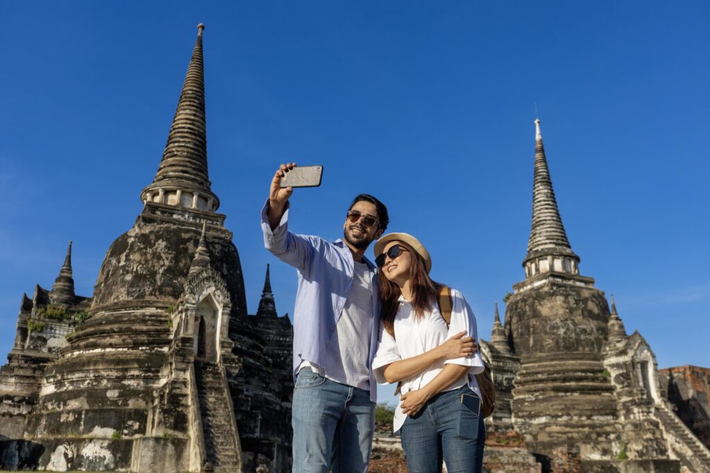 Couple of foreign tourists take selfie photo at Wat Phra Si Sanphet temple, Ayutthaya Thailand, for travel, vacation, holiday, honeymoon and tourism concept Stock Free