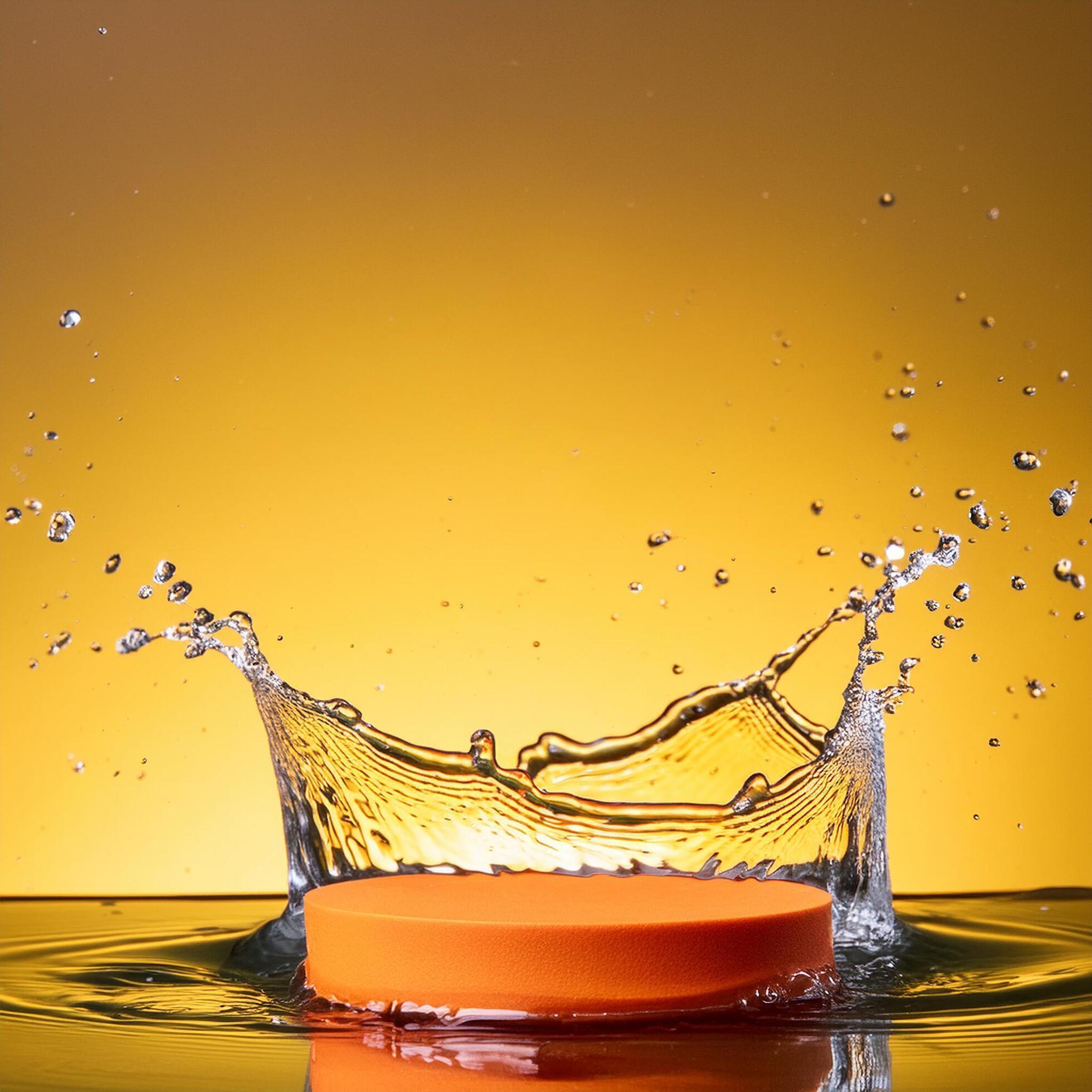 empty orange podium mockup with water splash on a gradient background for product display Stock Free