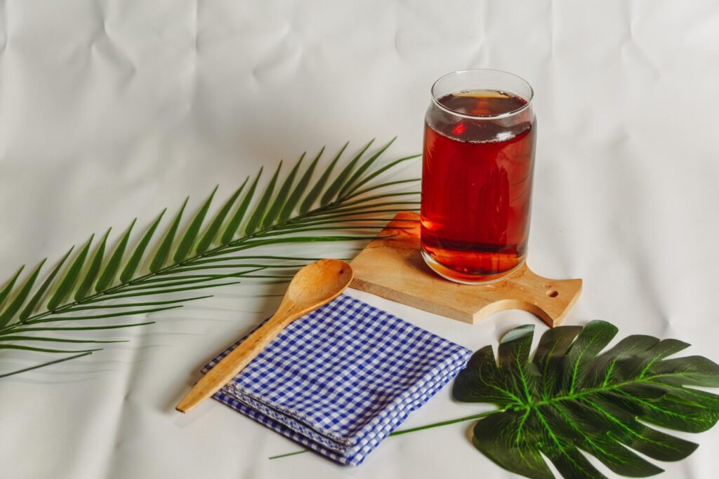 photography of a glass of tea and several elements on a white background Stock Free