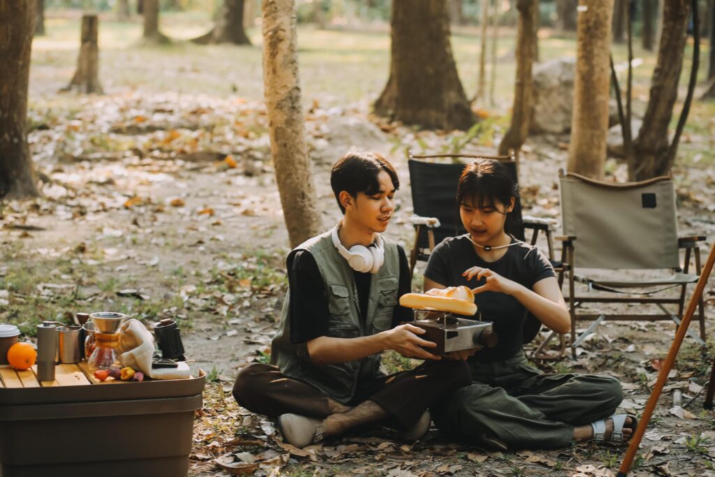 Asian couple sweet in tent inside on they camping trip, traveller relax and sleep togather in out door and camping trip Stock Free