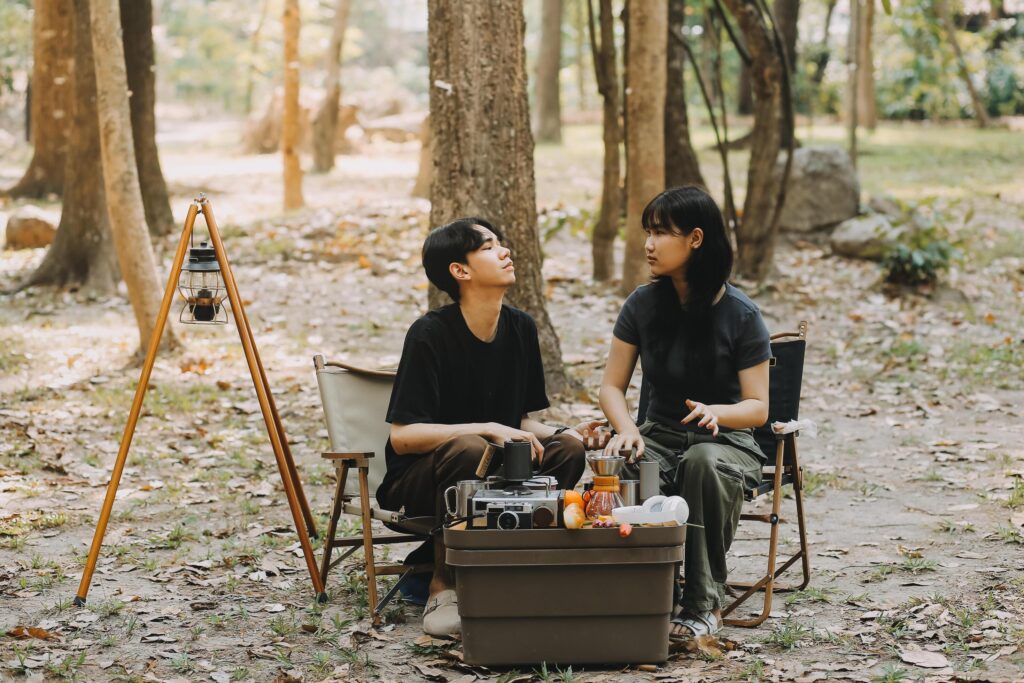 Asian couple sweet in tent inside on they camping trip, traveller relax and sleep togather in out door and camping trip Stock Free