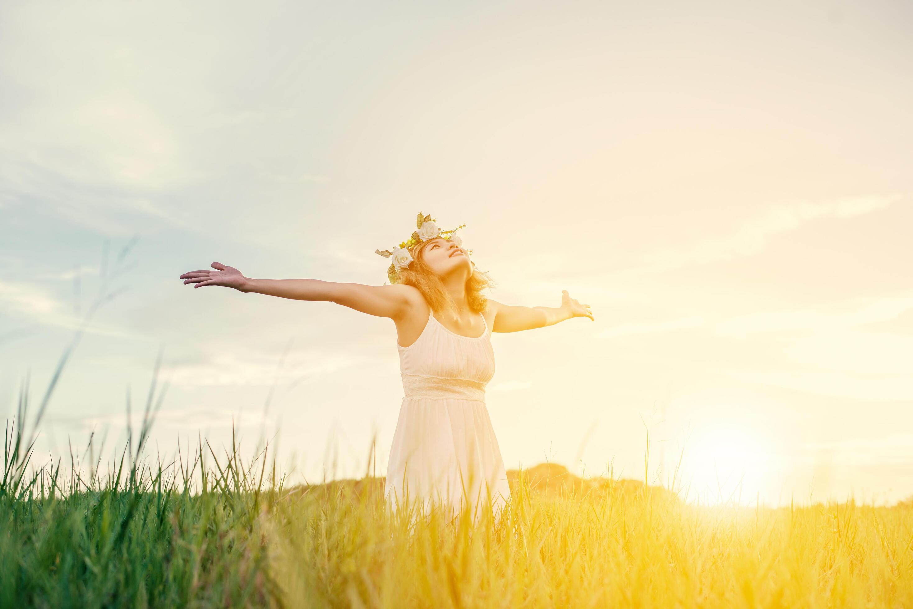 Freedom concept Young beautiful woman enjoying with fresh air and nature at meadows. Stock Free