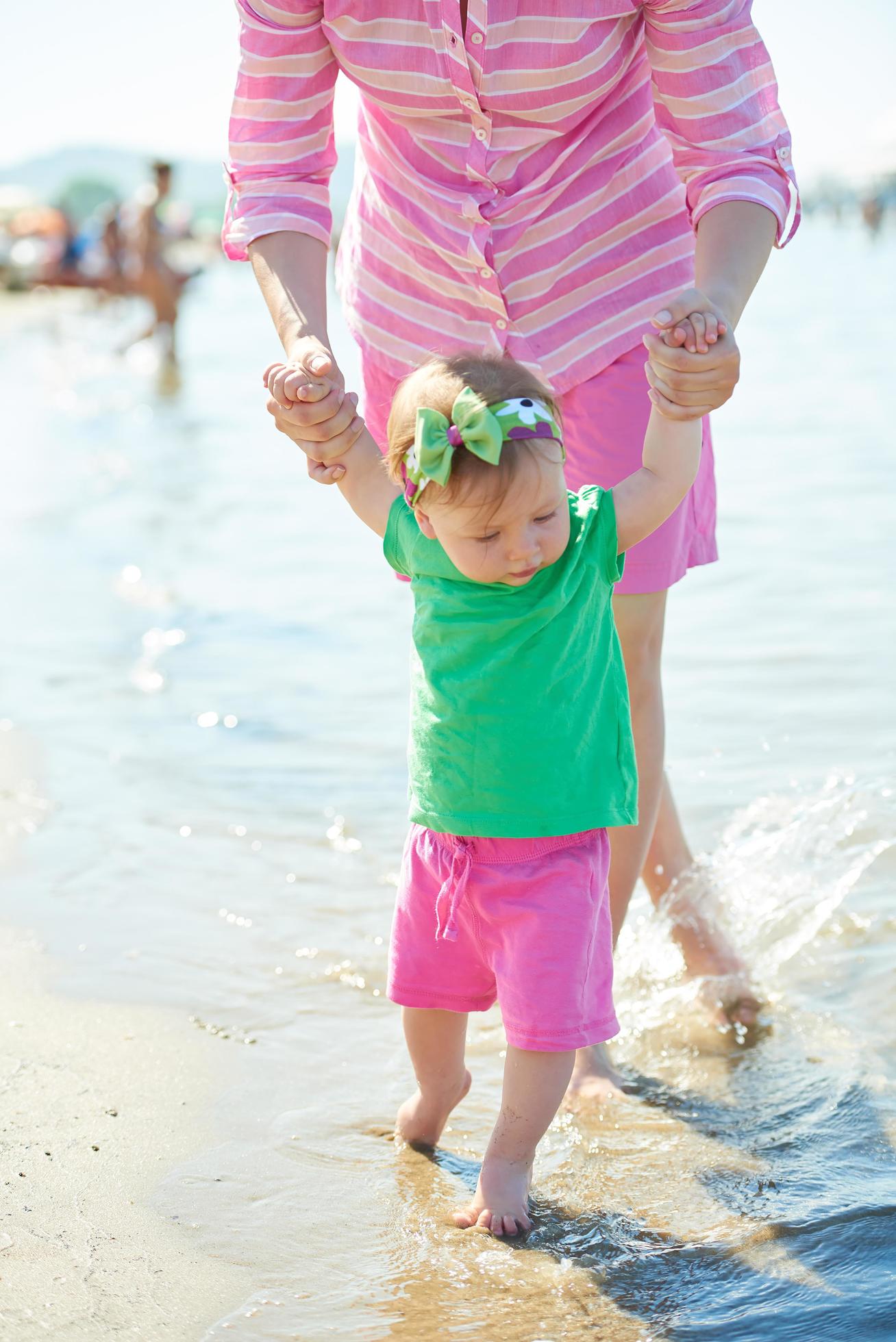 mom and baby on beach have fun Stock Free