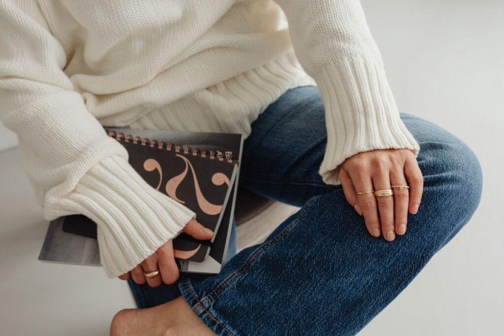 Woman in a white sweater – jewelry – laptop work – fashion Stock Free