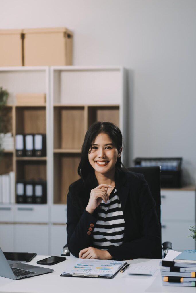 Young pretty business woman with notebook in the office Stock Free